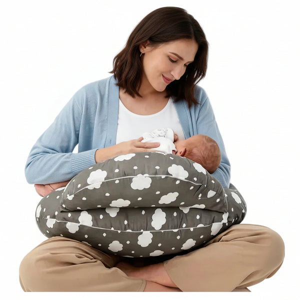 Woman breastfeeding a baby using a cloud-patterned nursing pillow on a white background